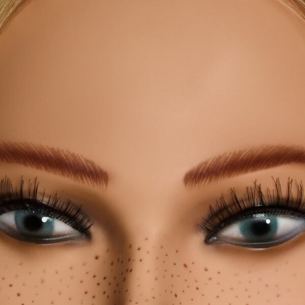 Close-up of L’IMAGE Liz 2608 competition mannequin head with freckles, realistic eyes and lashes